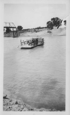 [The ferry (with two automobiles on it) crossing the Brazos River.]