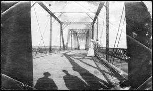 [Two women standing on a bridge.]