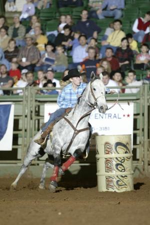 [Woman and Gray Horse Barrel Racing at Cowtown Coliseum]