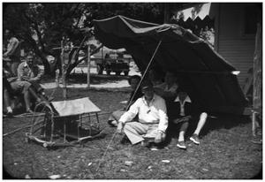 Primary view of object titled 'Group Sitting Under a Tent'.