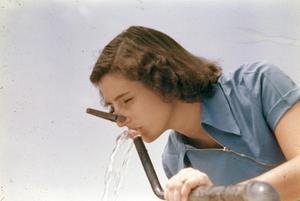 Girl Drinking Water with a Clothespin on Her Nose