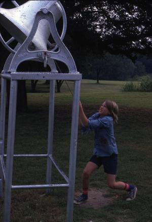A Young Boy Ringing a Large Bell