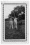 Photograph: [Two unknown young men practicing archery]