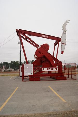 [Photograph of a Red Oil Derrick]