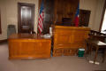 Photograph: [Desks at Front of Courtroom]