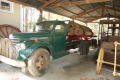 Photograph: [Photograph of a Green Log Truck]