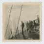 Photograph: [Men Standing on Boat]