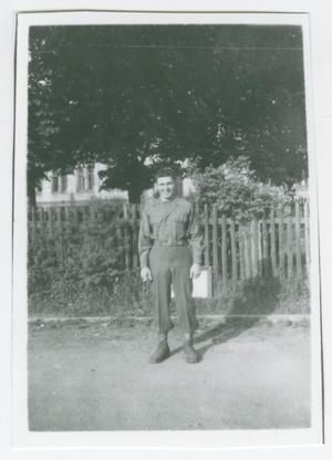Primary view of object titled '[Bill Shearer Standing in Front of a Fence in Heidenheim, Germany]'.