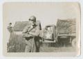 Photograph: [Soldier in Front of Truck]