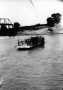 Photograph: Richmond Ferry on the Brazos River crossing with two autos.