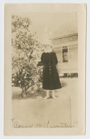 Primary view of object titled '[Photograph of Nannye Lea Foster next to Rose Bush]'.