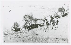 [Photograph of Trucks in Mud]