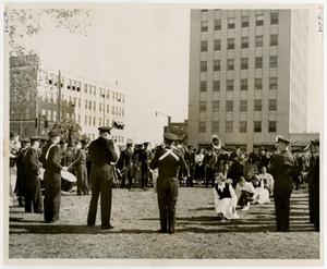 Primary view of object titled 'Band Members and Dance Routine Performing in Front of Sykes Pharmacy'.