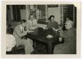Photograph: Five People at a Table Casually Having Tea/Coffee
