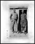 Photograph: Two Men at Cabin Door