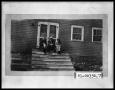 Photograph: Man with Two Women on Porch Steps