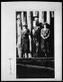 Photograph: Man and Two Women at Log Cabin