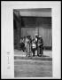 Photograph: Man, Two Women, and Child on Sidewalk