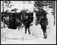 Photograph: Men Standing in Snow by Cabin
