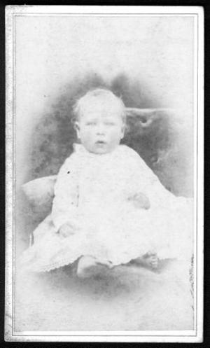 [An infant in a white dress. Infant has bare feet.]