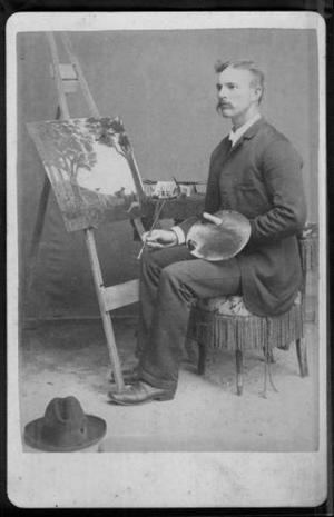 [A man sitting in a tasseled chair with paint palette.]