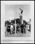Photograph: People Standing Around Statue