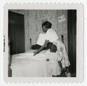 Primary view of object titled '[Woman Folding Sheets]'.