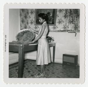 Primary view of object titled '[Goldie Hodge Holding a Plate]'.