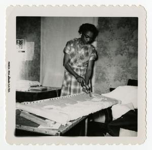 Primary view of object titled '[Woman Cutting Fabric]'.