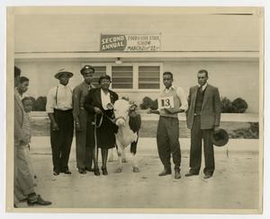 [People and a Cow at the Food and Livestock Show]
