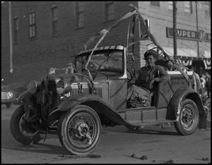 Primary view of object titled '[Photograph of a Car in a Rodeo Parade]'.