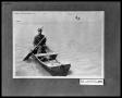 Photograph: Man in Wooden Flat Bottom Boat