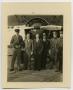 Photograph: [Men Standing in Front of Airplane]