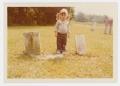 Photograph: [Child with Headstones]