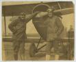 Photograph: [Lieutenant Cole and Sergeant Fuller Leaning on a Biplane]