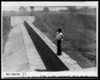 Photograph: Woman Standing on Dam