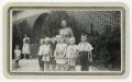 Photograph: [Teacher with Students in Front of Purmela School]