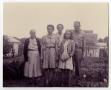 Image: [People Standing in a Yard by Two Houses]