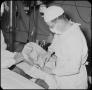 Photograph: [Photograph of Doctor Performing Surgery]