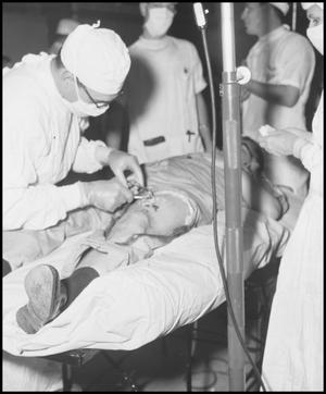 [Photograph of Doctors Performing Surgery]