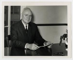 Primary view of object titled '[Photograph of Oliver A. Bush at Desk]'.