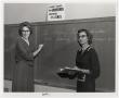 Photograph: [Photograph of Two Teachers at Front of Classroom]