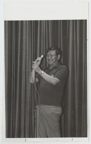 [Photograph of Dr. Thomas Kim with Microphone]