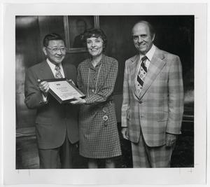 [Photograph of Dr. Thomas Kim Presenting an Award]