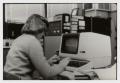 Photograph: [Photograph of Office Worker on Computer]
