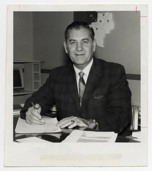 [Photograph of Wilfred Moore Seated at Desk]