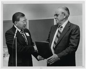 [Photograph of Dr. Thomas Kim and Mr. Hunt]