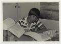 Primary view of [Photograph of Student Studying Law Books]
