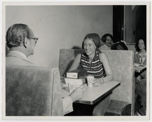 Primary view of object titled '[Photograph of Couple in Cafeteria Booth]'.