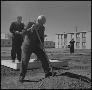 [Photograph of Man Shoveling Dirt at the Groundbreaking Ceremony for the Jay-Rollins Library]